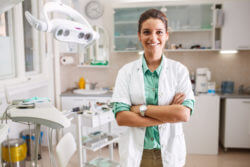 female dentist smiling exam room